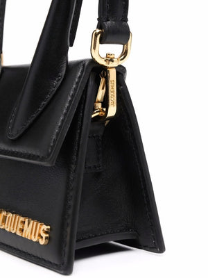 JACQUEMUS Black Leather Mini Handbag with Oversized Handle and Magnetic Flap Closure