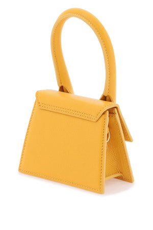 أصلي: حقيبة جلدية بمقبض برتقالي للنساء - مجموعة SS24