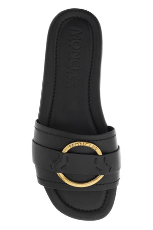 MONCLER Black Calfskin Slide for Women Featuring a Round Toe and Gold Metal Ring Band with Engraved Logo