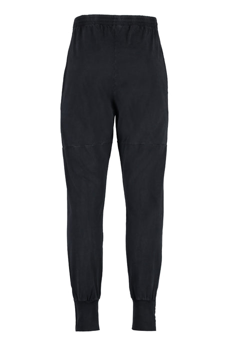 Quần track-pants nam cotton đen với zipper bên và chi tiết cắt xén