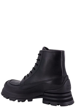 ALEXANDER MCQUEEN Men's Black Leather Ankle Boots with Oversized Sole and Iconic Logo Print