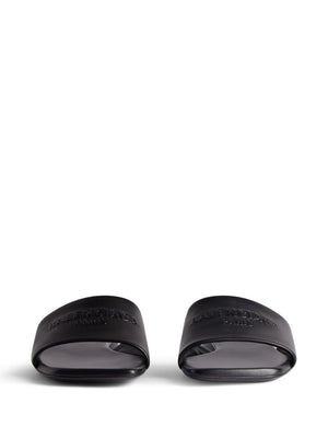 BALENCIAGA Black Leather Flat Sandals for Women with Embossed Logo and Slip-On Style