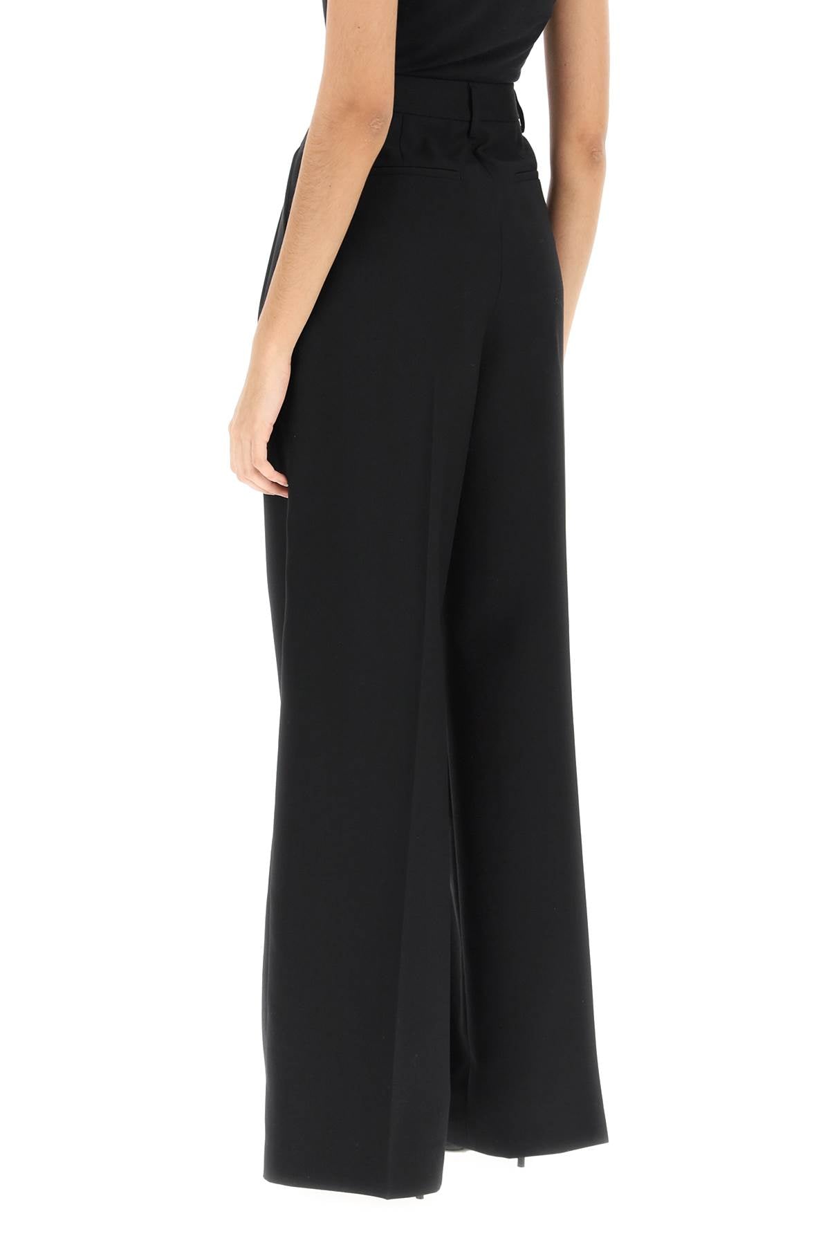 Pleated Wide-Leg Wool Trousers in Black - مجموعة الربيع/الصيف 2024